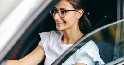 Eine Frau sitzt lächelnd am Steuer eines Fahrzeugs. Firmenwagen-Leasing mit Fleethouse bietet Unternehmen eine moderne, digitale Lösung für die Bereitstellung von Dienstfahrzeugen – flexibel, steuerlich attraktiv und optimal für ein effizientes Fuhrparkmanagement.